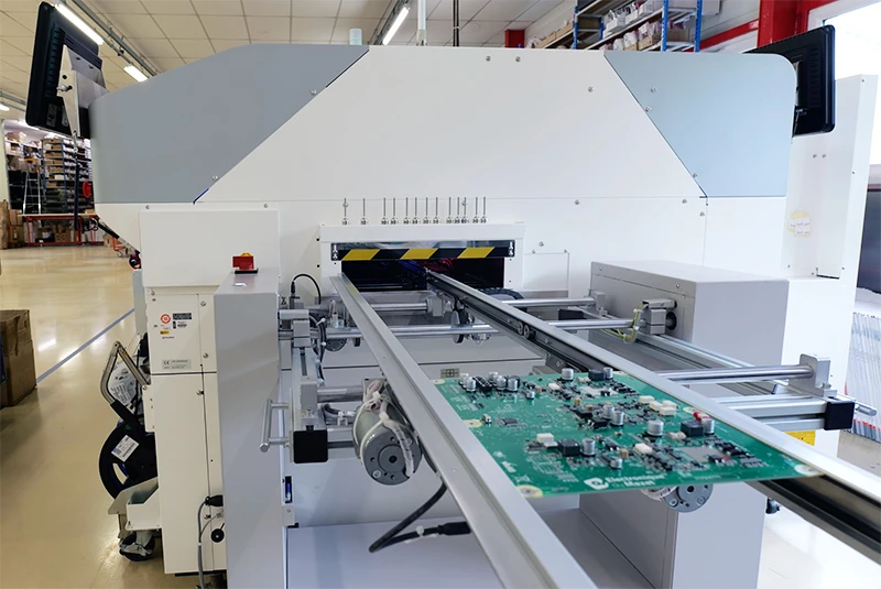 Automated industrial machine for assembling and soldering electronic boards at Mazet Santé, ensuring high-precision French manufacturing